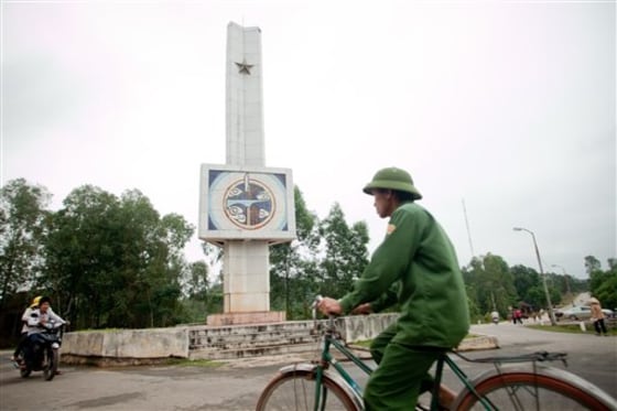 Riders pass the historic Dong Loc T-junction Monument, Ha Tinh Province, Vietnam on Tuesday. A poll shows the people of Vietnam rarely think about a conflict that still ignites political passions in the U.S.